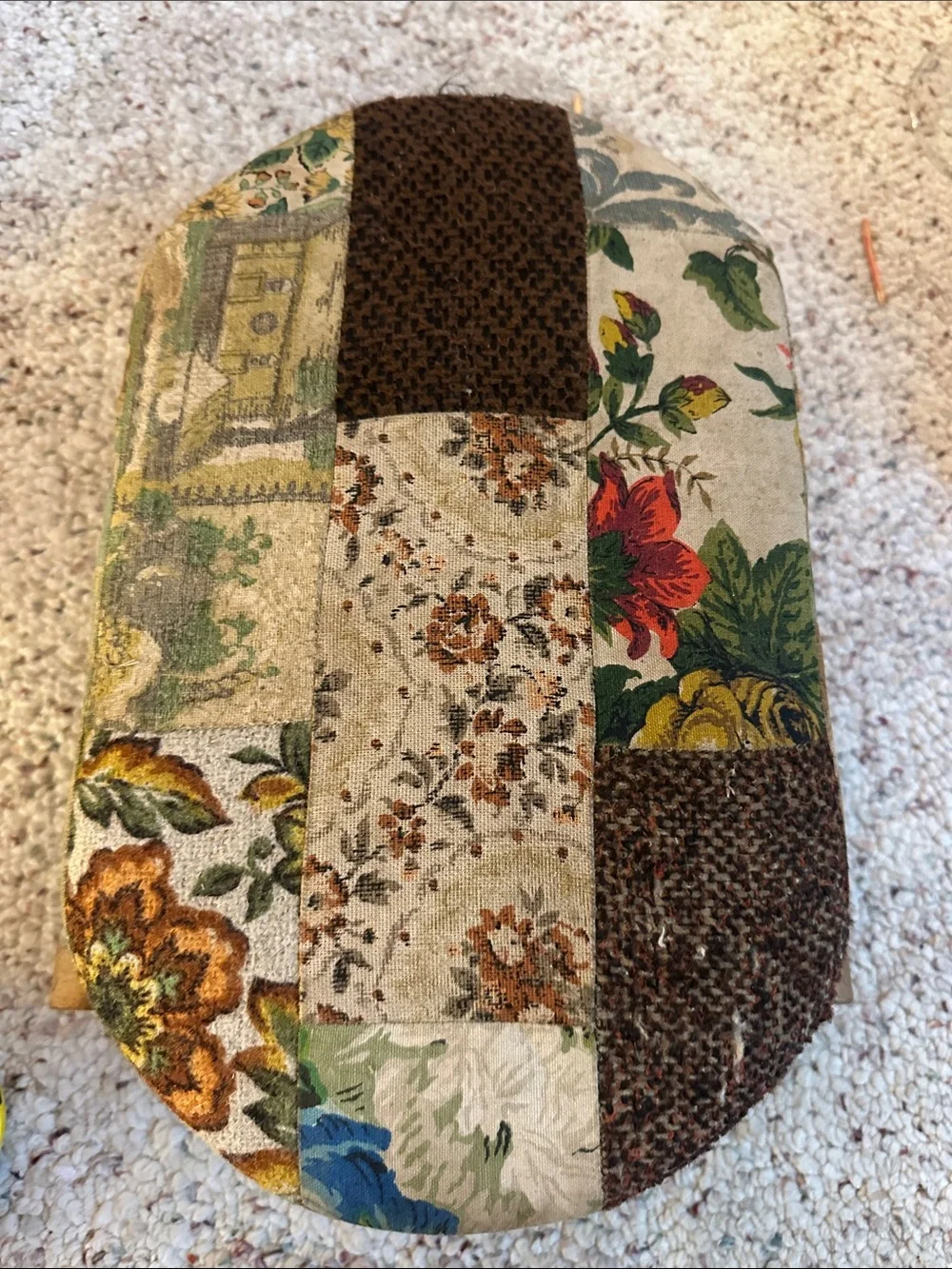 Antique wooden rocking footstool features a charming multicolor floral tapestry